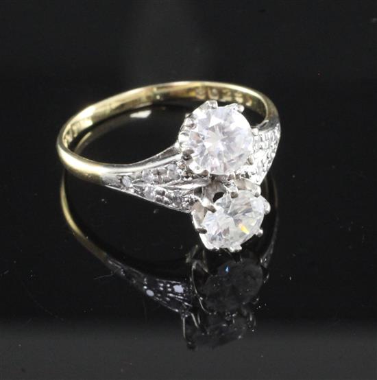 An 18ct gold and platinum, two stone diamond ring with diamond set shoulders, size S.